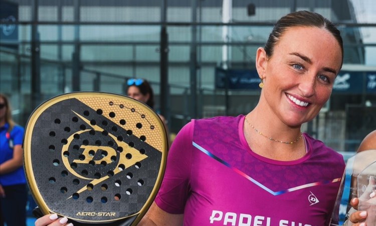 GB padel player Aimee Gibson posing with a trophy after a win