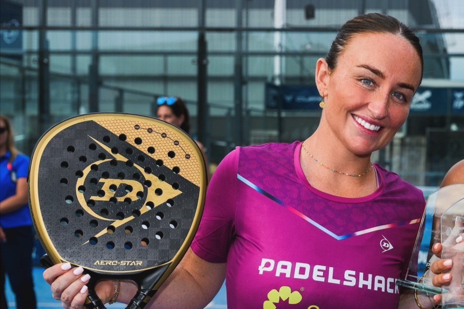 GB padel player Aimee Gibson posing with a trophy after a win