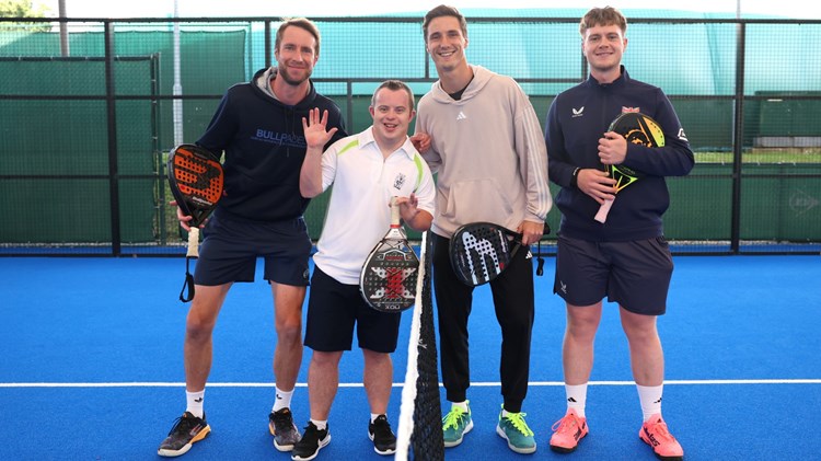 Joe and Chris Salisbury pose on the padel court with two young players