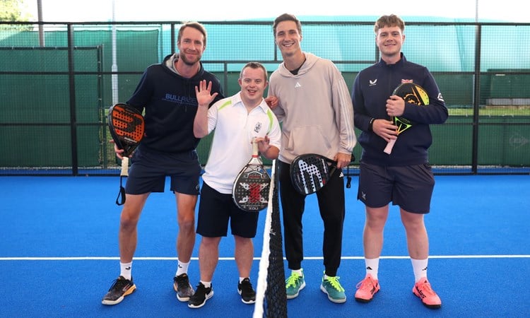 Joe and Chris Salisbury pose on the padel court with two young players