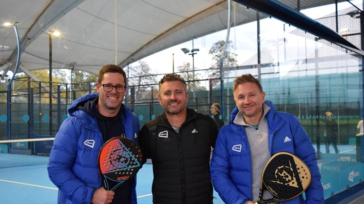 Matt Stanforth, Jordi Munoz and Tom Murray holding padel rackets and stood in front of padel courts