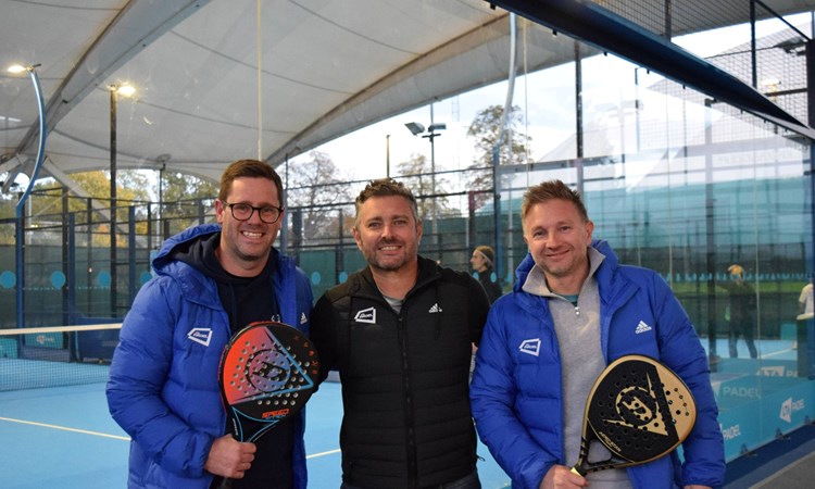 Matt Stanforth, Jordi Munoz and Tom Murray holding padel rackets and stood in front of padel courts