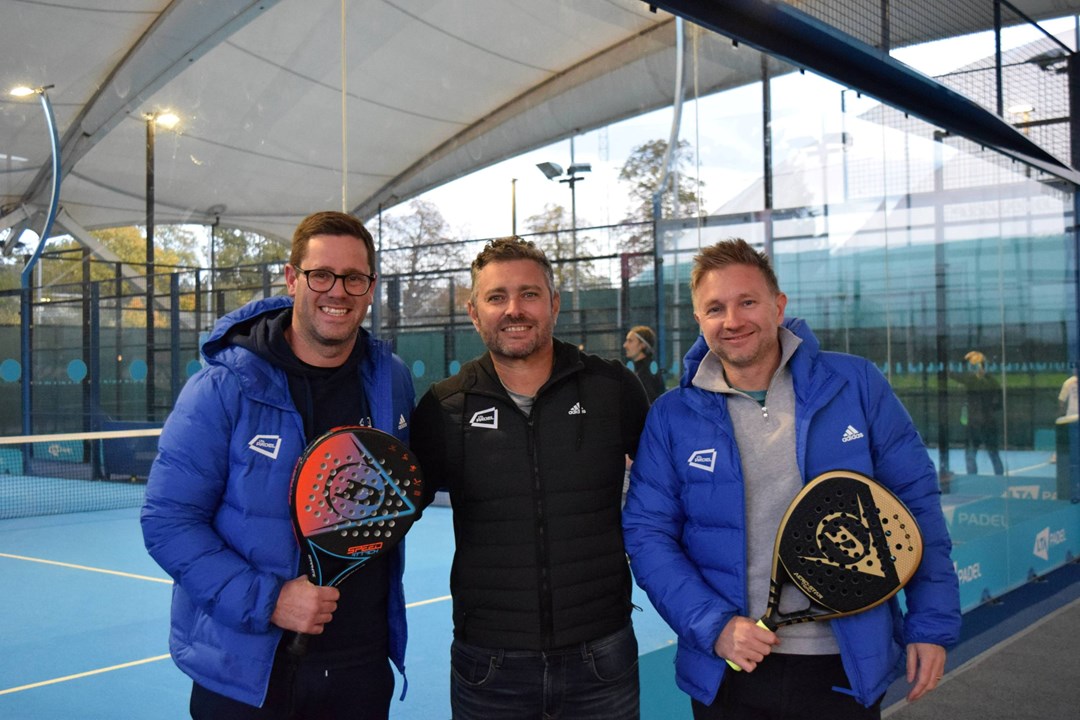 Matt Stanforth, Jordi Munoz and Tom Murray holding padel rackets and stood in front of padel courts