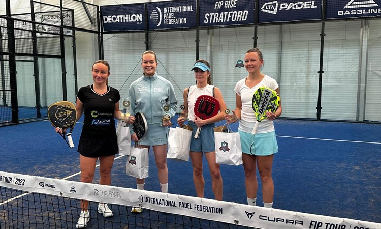 Four female padel players pose for photo with prizes after the  LTA Padel British Tour event in Stratford