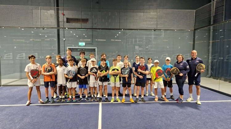 Libby Fletcher and Steve Yeardley stood on court with their junior padel players at the National Performance Junior Camps