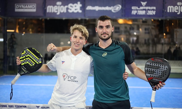 Christian Medina Murphy and Belar Vera Lopez pose on a padel court after winning title
