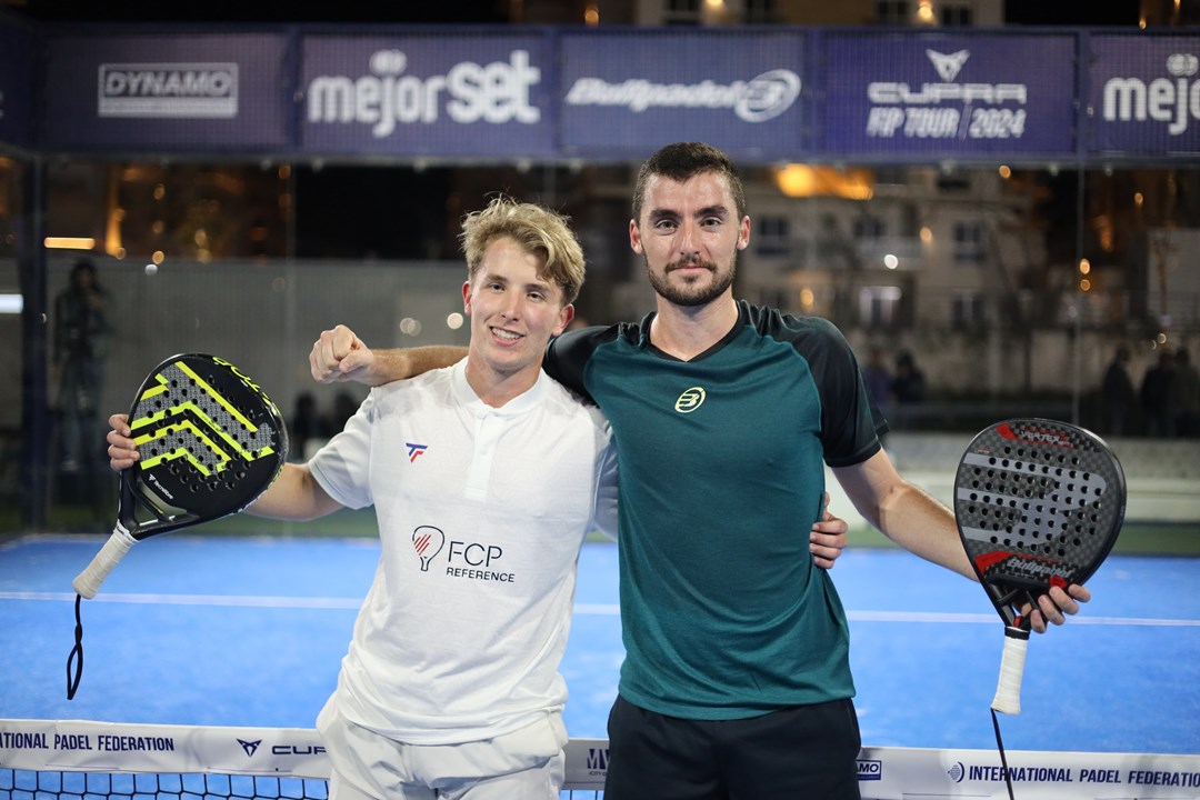 Christian Medina Murphy and Belar Vera Lopez pose on a padel court after winning title
