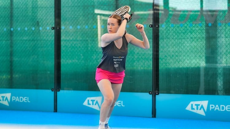 Tia Norton hits a forehand shot on a padel court at the National Tennis Centre