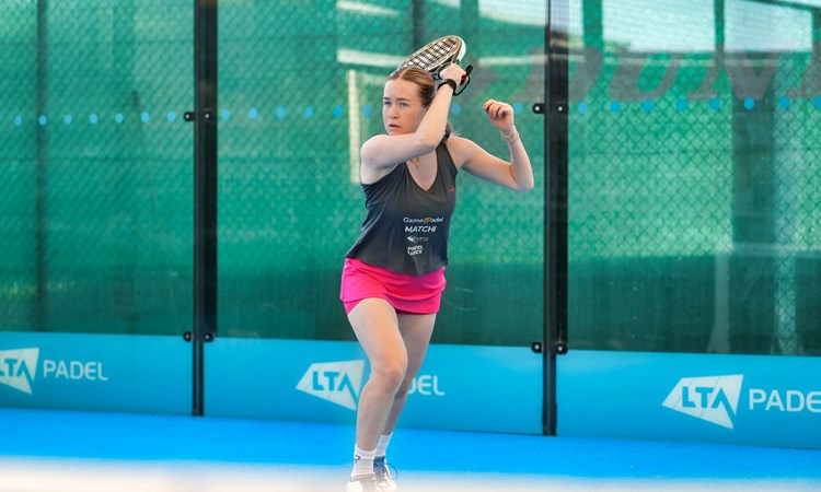 Tia Norton hits a forehand shot on a padel court at the National Tennis Centre