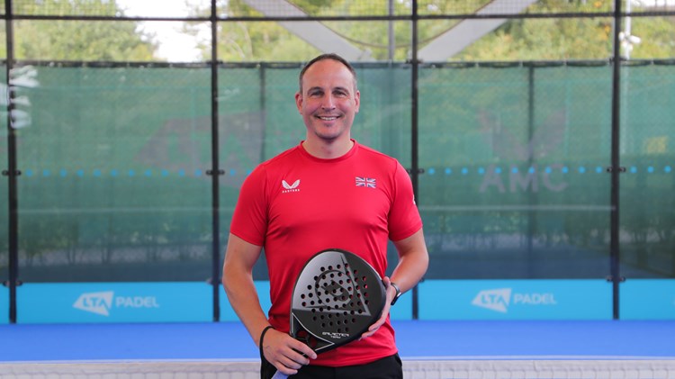 LTA Padel Manager Steve Yeardley standing on a padel court wearing a red t-shirt.