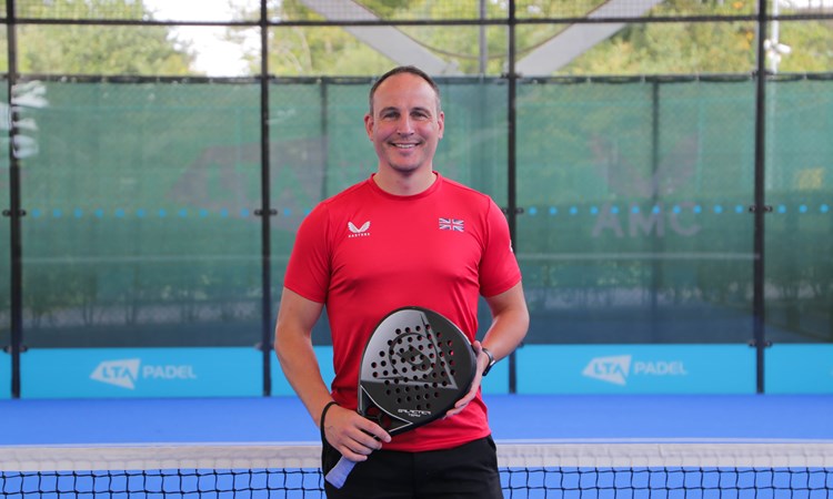 LTA Padel Manager Steve Yeardley standing on a padel court wearing a red t-shirt.