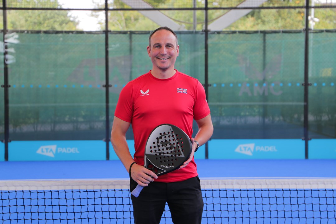 LTA Padel Manager Steve Yeardley standing on a padel court wearing a red t-shirt.