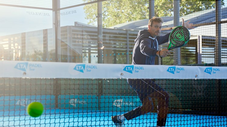Player hitting a volley on a padel court