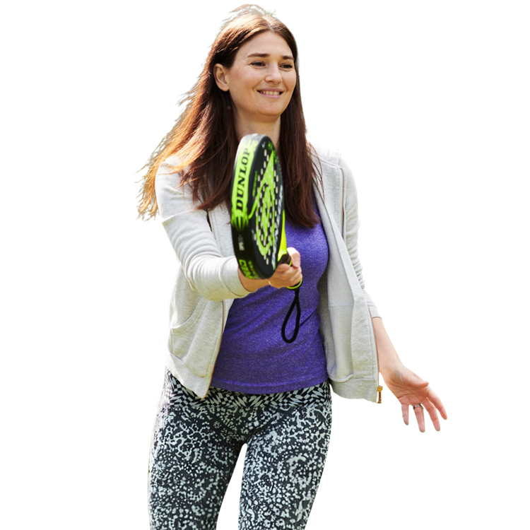 Woman playing padel, about to hit the ball with her racket