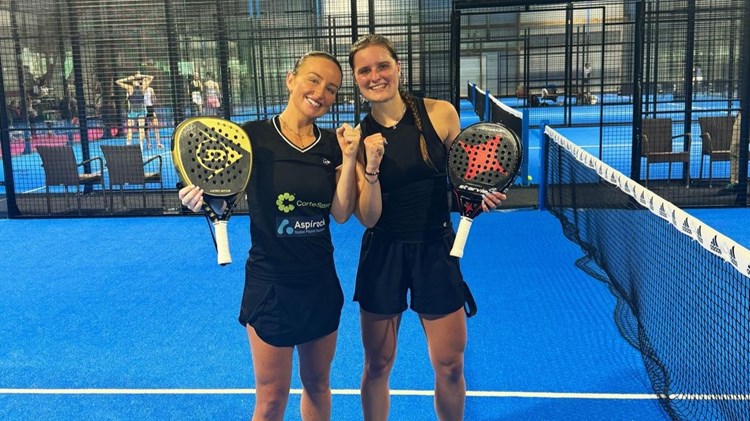 Aimee Gibson and Maaike Betz pose on court with their rackets