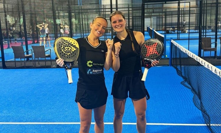 Aimee Gibson and Maaike Betz pose on court with their rackets