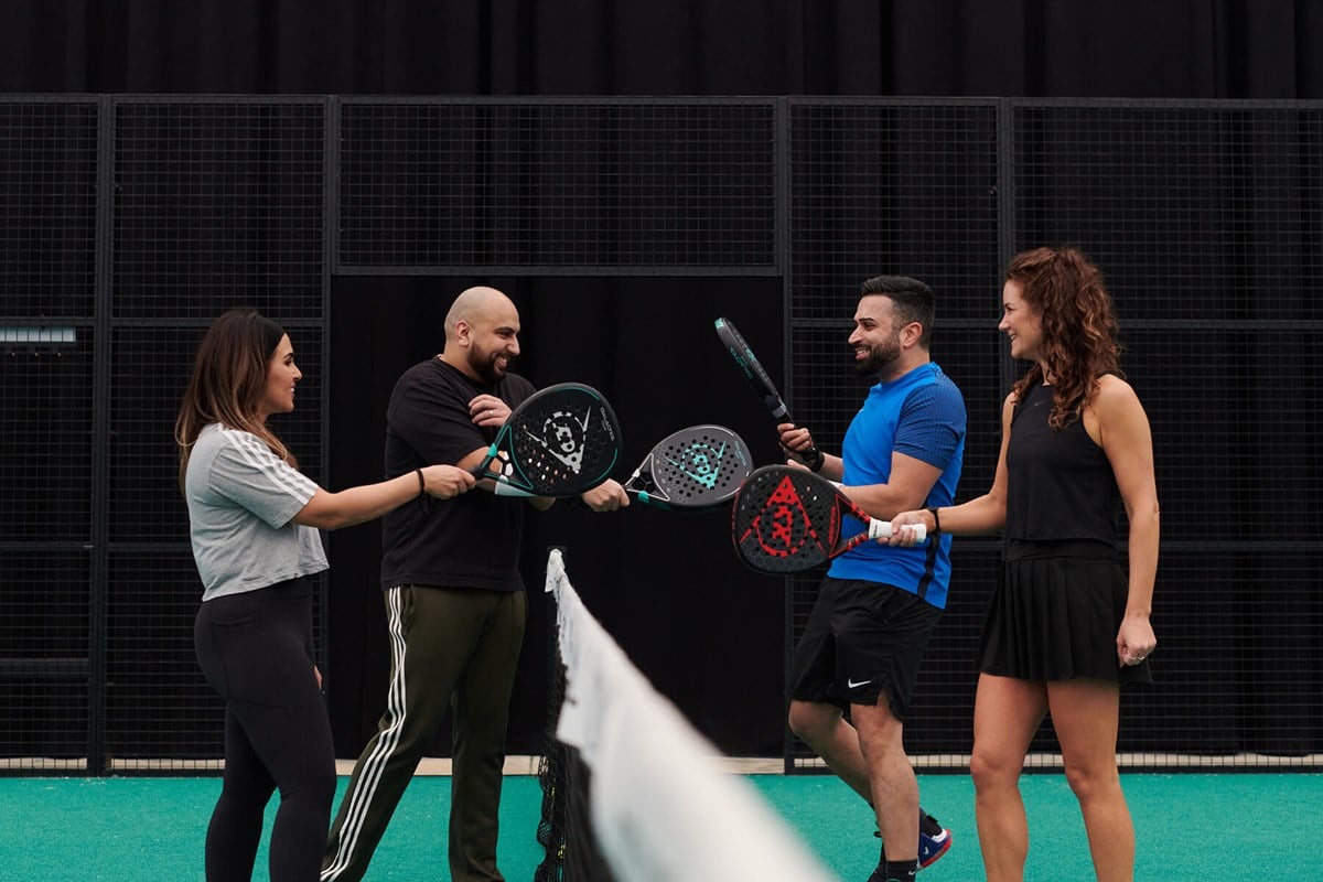 player-tapping-rackets-at-net.jpg