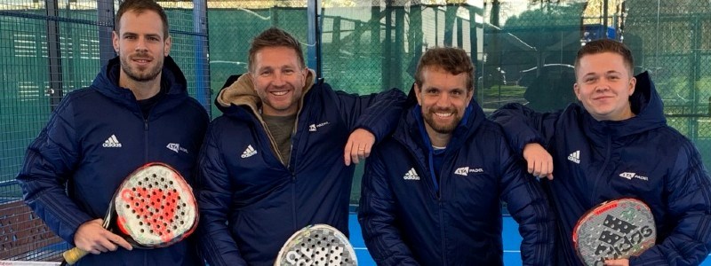 Four padel volunteers smiling