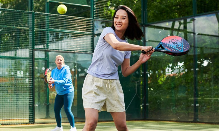 Woman preparing to hit a backhand in padel