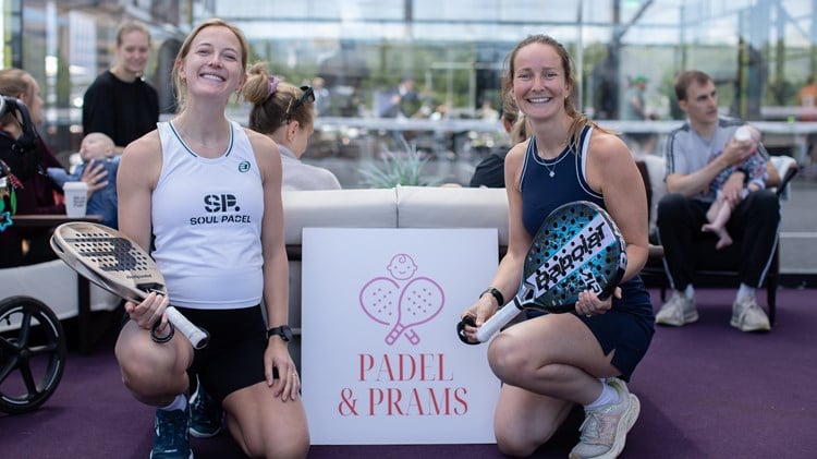 Two women posing with the Padel & Prams sign