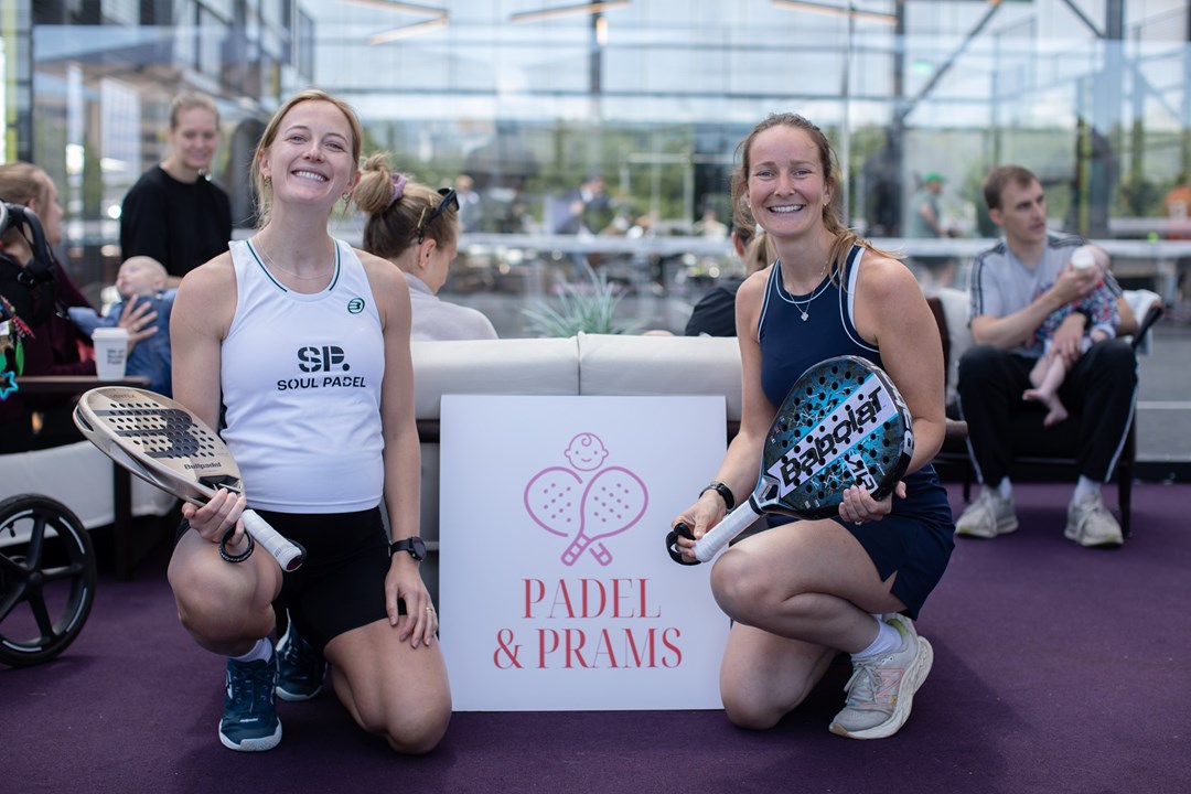 Two women posing with the Padel & Prams sign