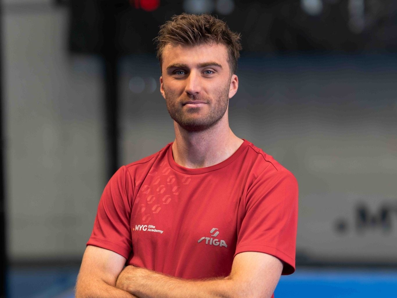 British padel player staring at the camera while crossing his arms