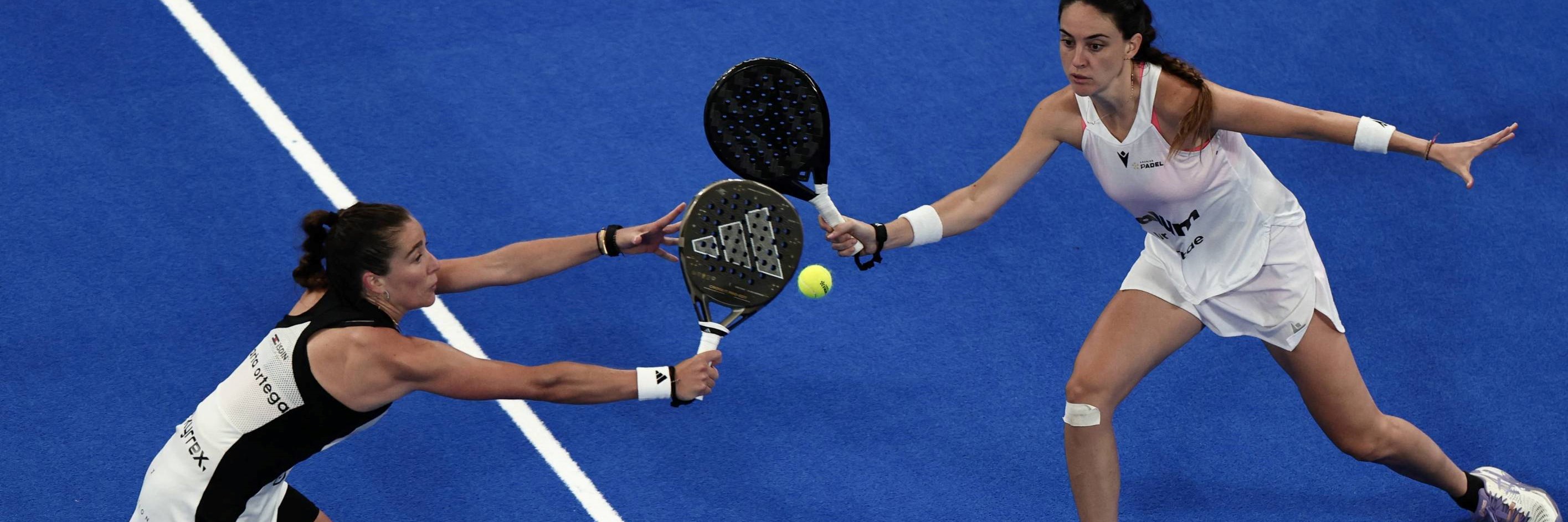 Two women's players reaching for a volley in the Premier Padel Tour