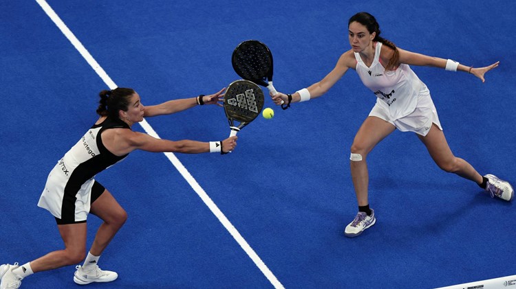 Two women's players reaching for a volley in the Premier Padel Tour