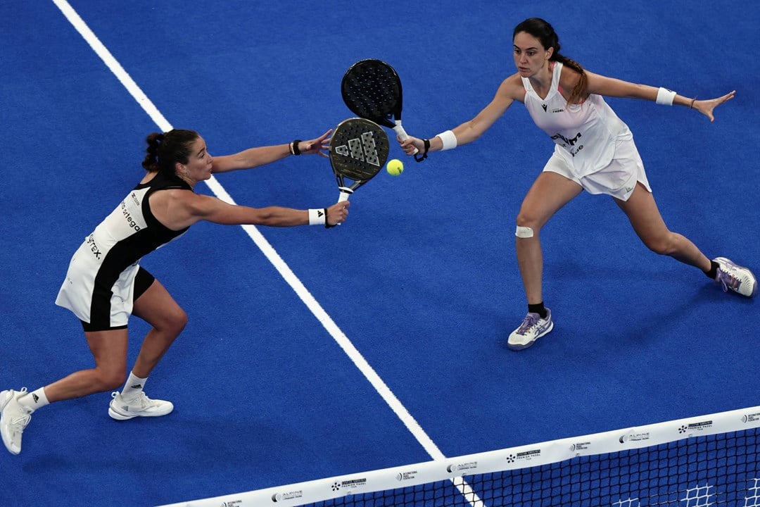 Two women's players reaching for a volley in the Premier Padel Tour