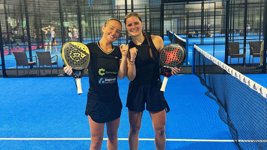 Aimee Gibson and Maaike Betz pose on court with their rackets