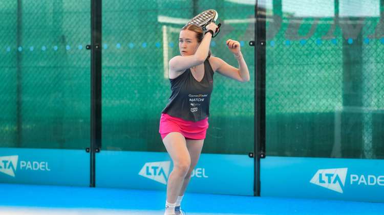 Tia Norton hits a forehand shot on a padel court at the National Tennis Centre