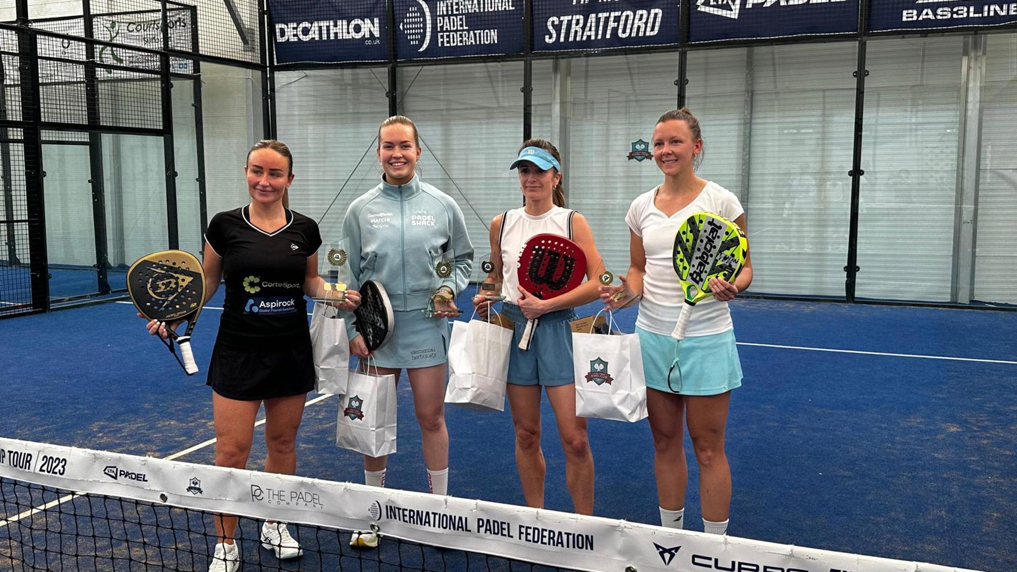 Four female padel players pose for photo with prizes after the  LTA Padel British Tour event in Stratford