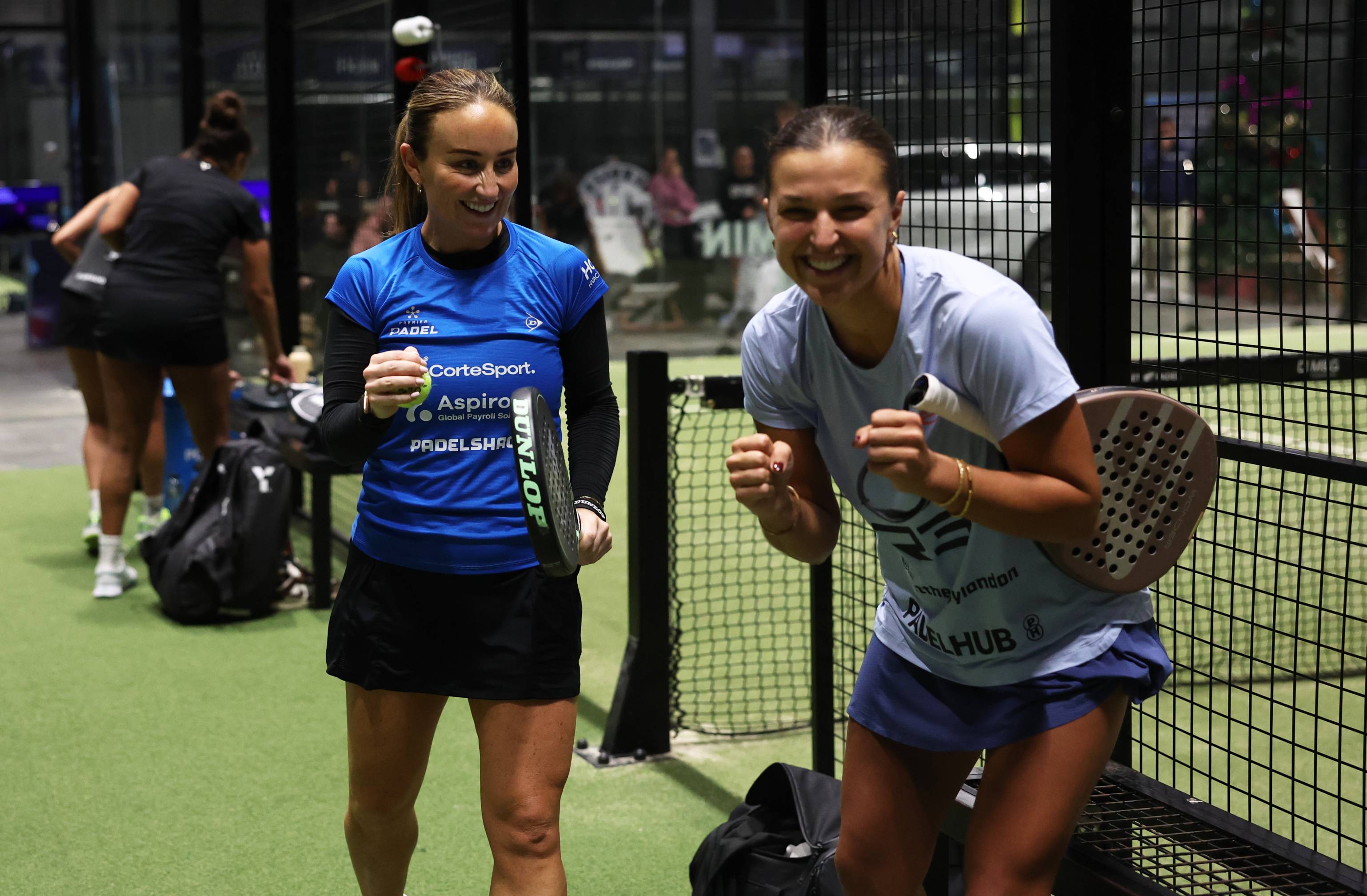 Aimee Gibson and Catherine Rose celebrate off court after a win at the LTA Padel National Championships