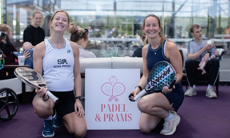 Two women posing with the Padel & Prams sign