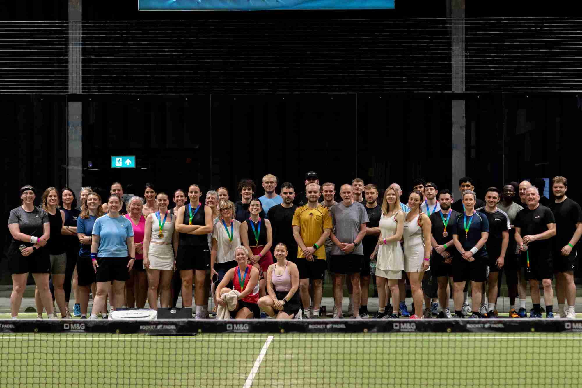 A large group of padel plays all coming together for a Pride Padel event