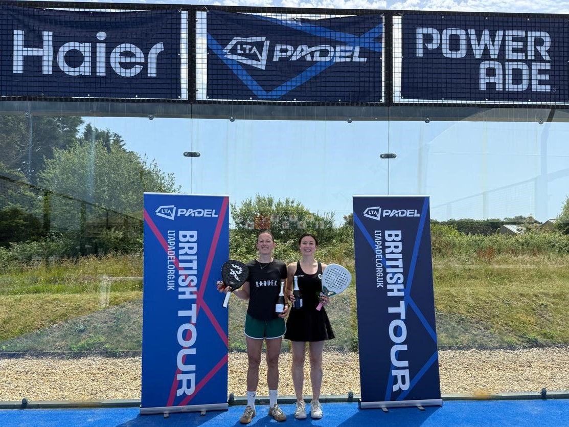 Vic Nicholas and Alice Keddie posing with LTA Padel British tour banners after winning a grade 1 evenr