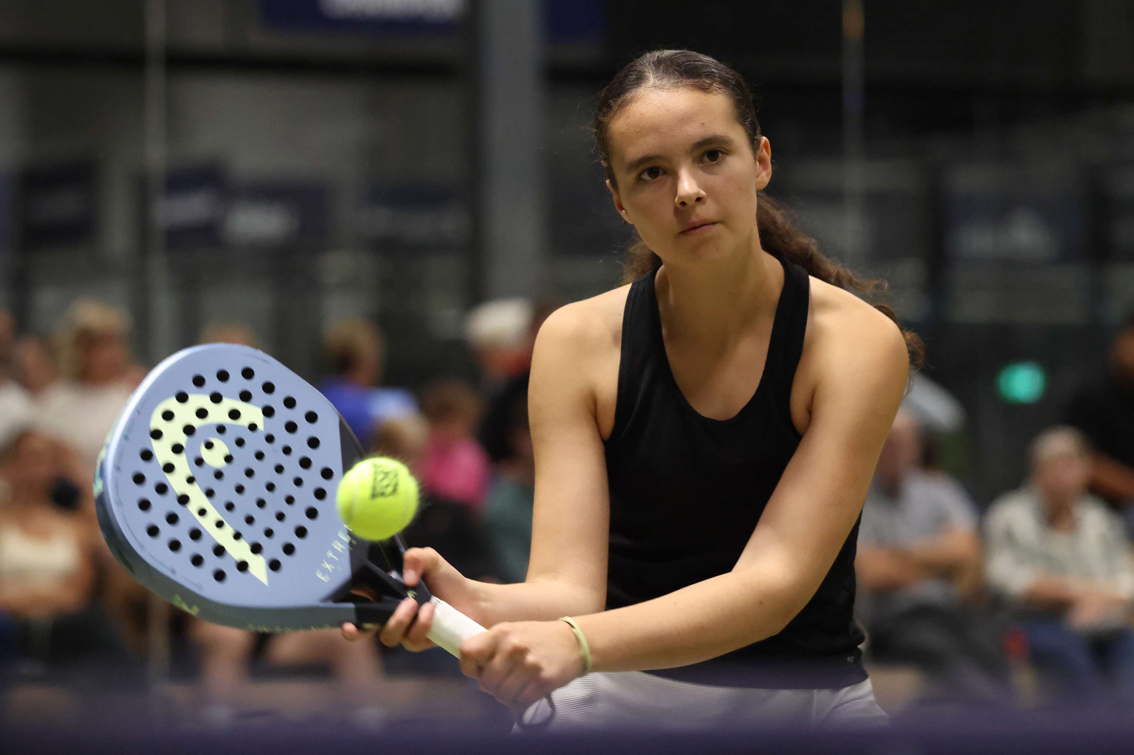 British padel player Chloe De La Mare hitting a backhand on a court at the LTA Padel National Championships 