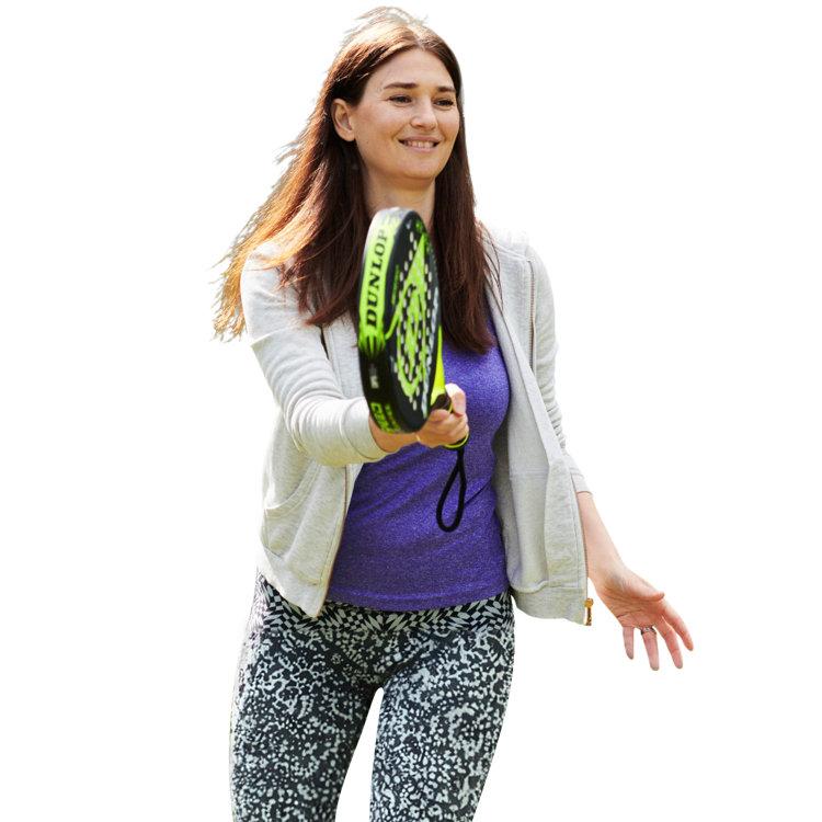 Woman playing padel, about to hit the ball with her racket