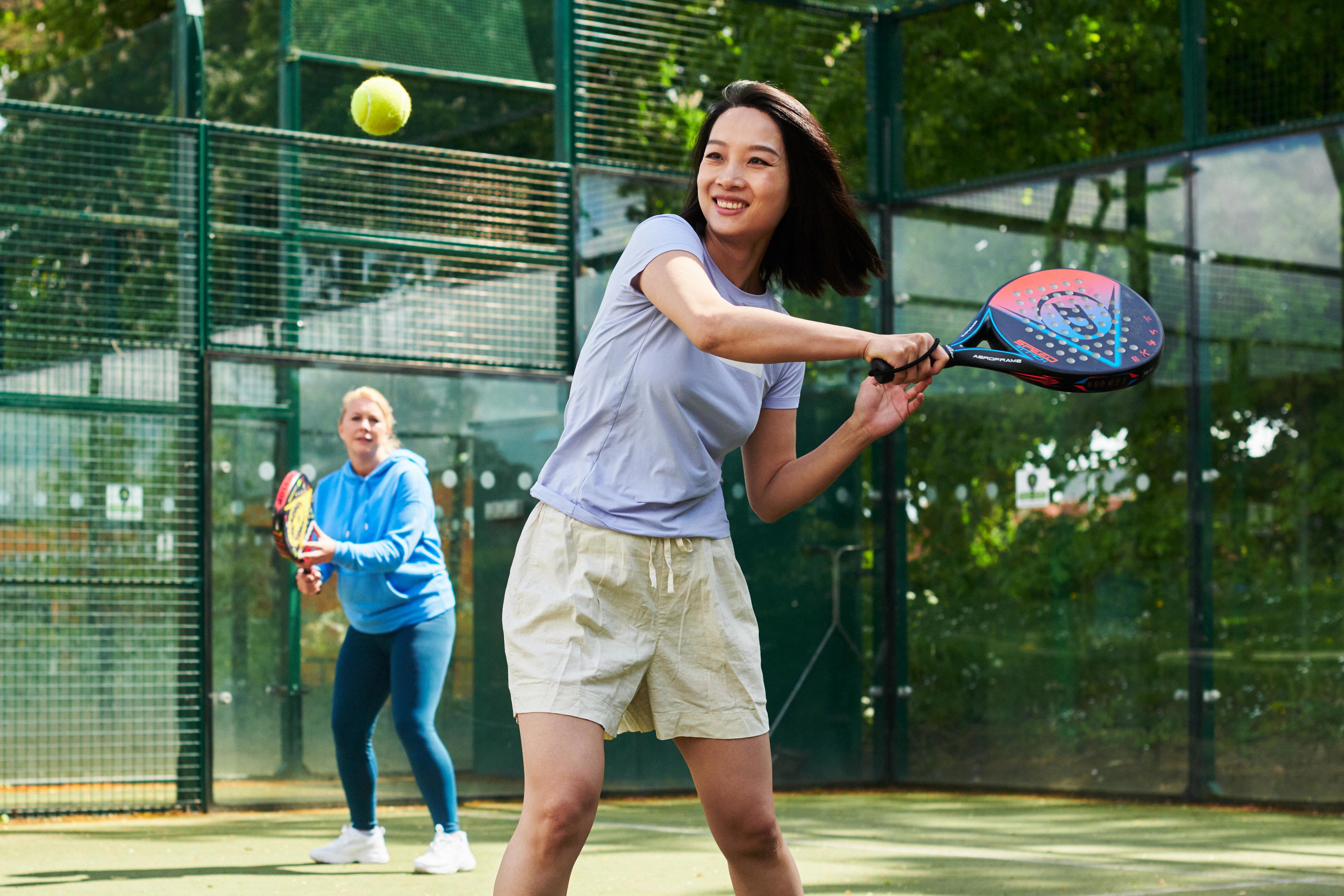 Woman preparing to hit a backhand in padel