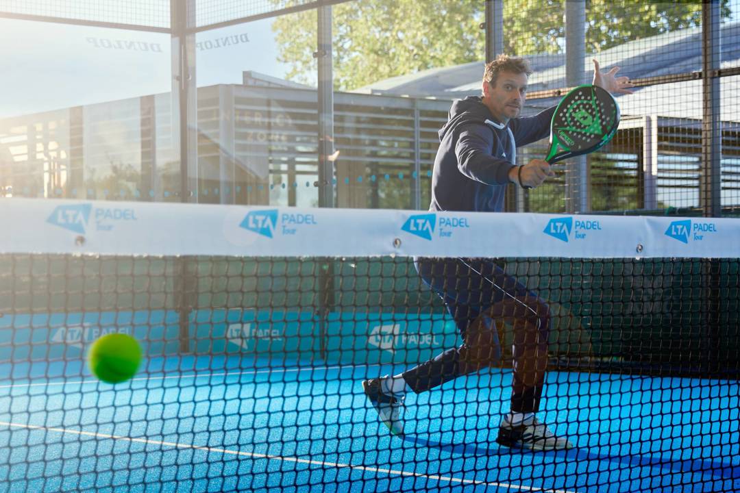 Player hitting a volley on a padel court
