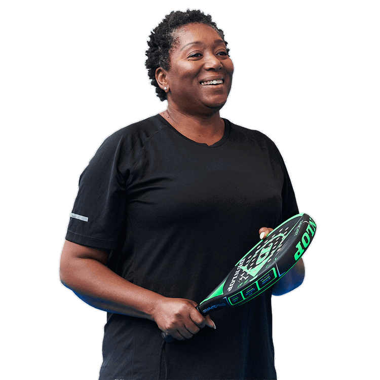 Women smiling holding a padel racket 